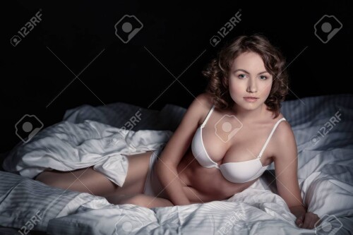 37125864-woman-in-underwear-lying-on-a-bed-in-a-dark-room.md.jpg