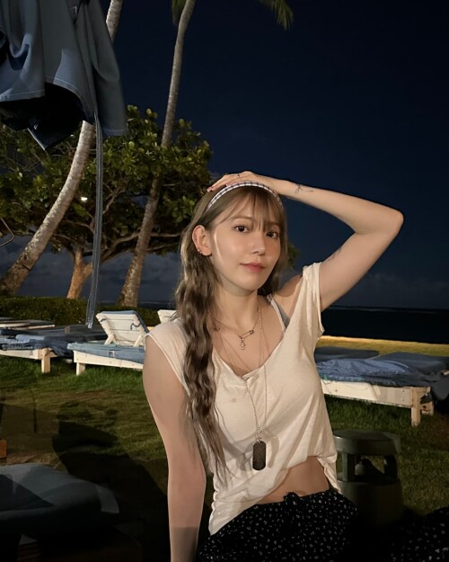 Photo by Sakura Miyawaki on September 24, 2024. May be an image of 1 person, hair, beach and palm tr