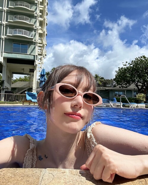 Photo by Sakura Miyawaki on September 24, 2024. May be an image of 1 person, swimming, eyewear, pool